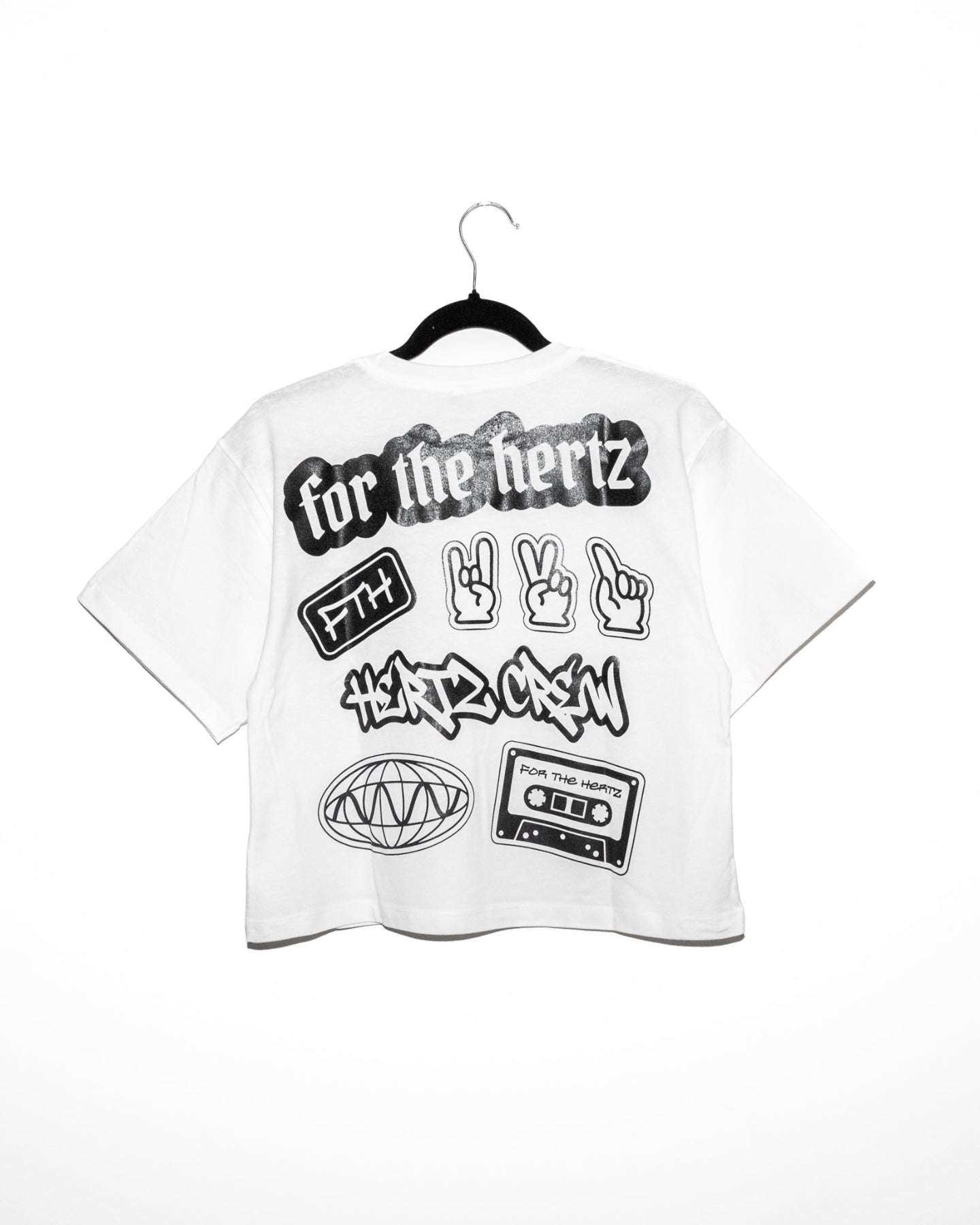 White boxy crop t-shirt with words, stickers, and logo on the back.
