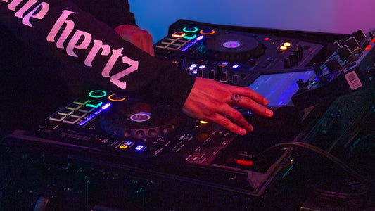 dj playing controller wearing hertz crew skull long sleeve shirt
