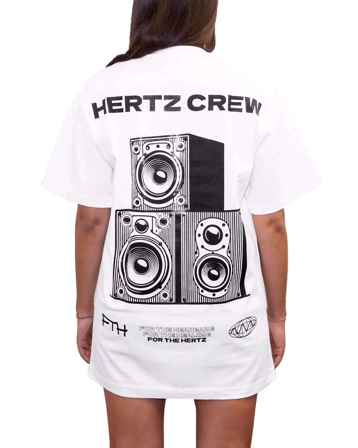 Woman wearing oversized white t-shirt with the words hertz crew and a graphic of a speaker on the back.