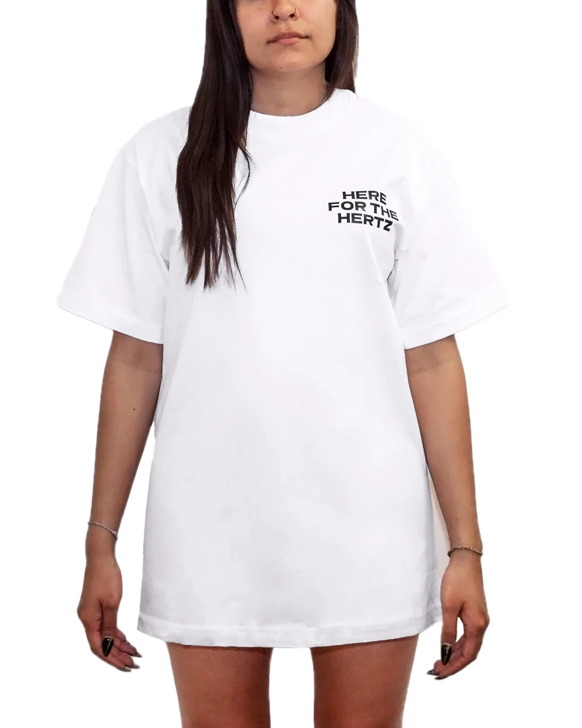 Woman wearing oversized white t-shirt with the words here for the hertz on the front pocket area.